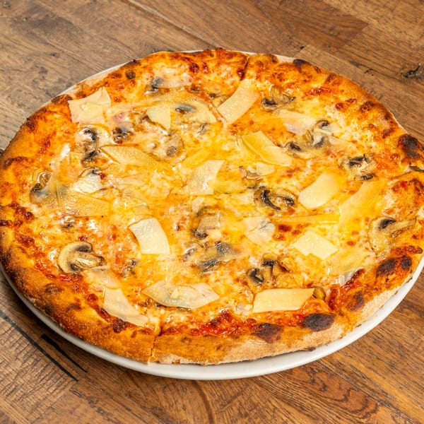 Tutto Pizza & Pasta's mushroom and cheese pizza with a golden crust on a wooden table.
